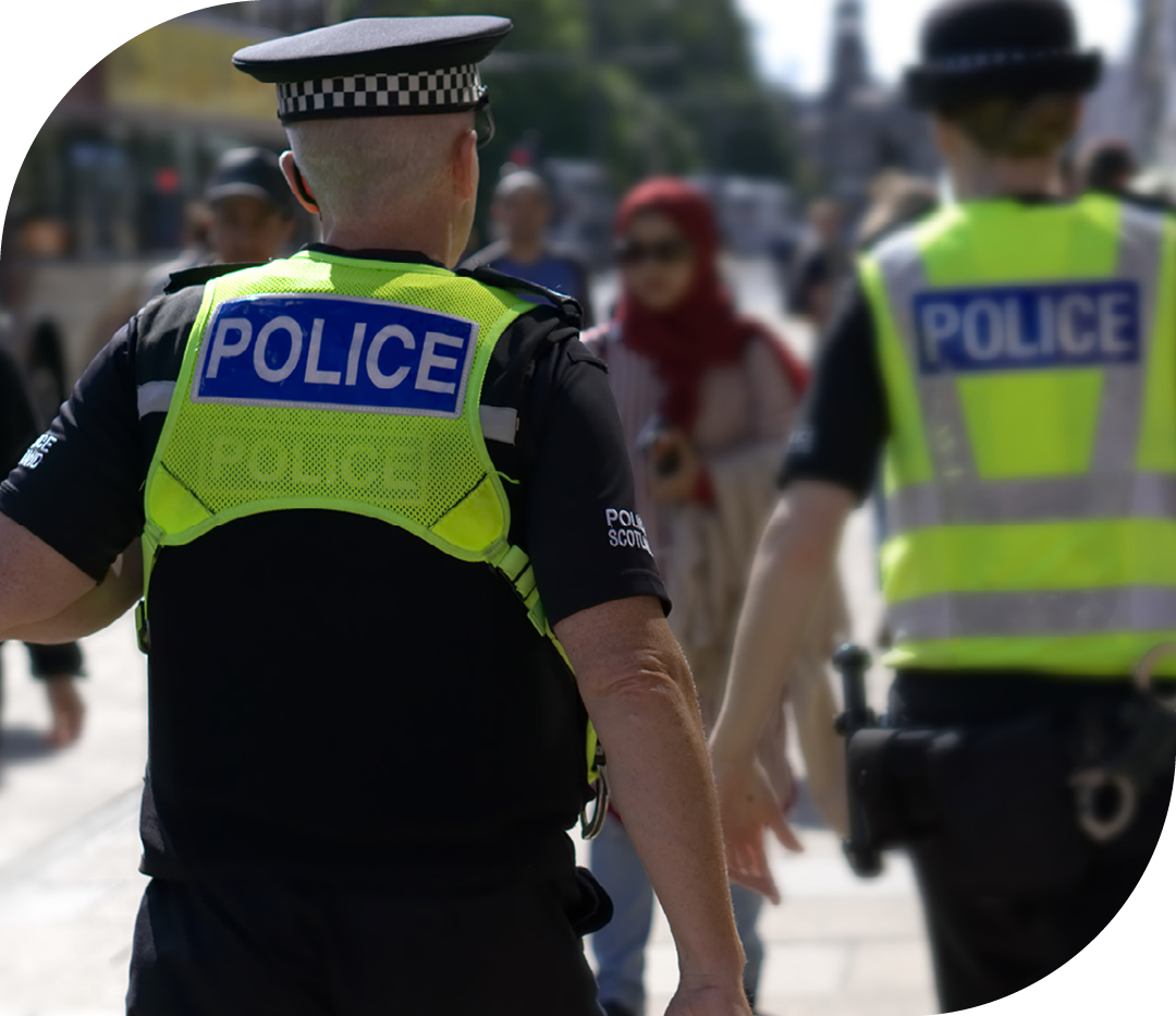 Image of two police officers walking through a street