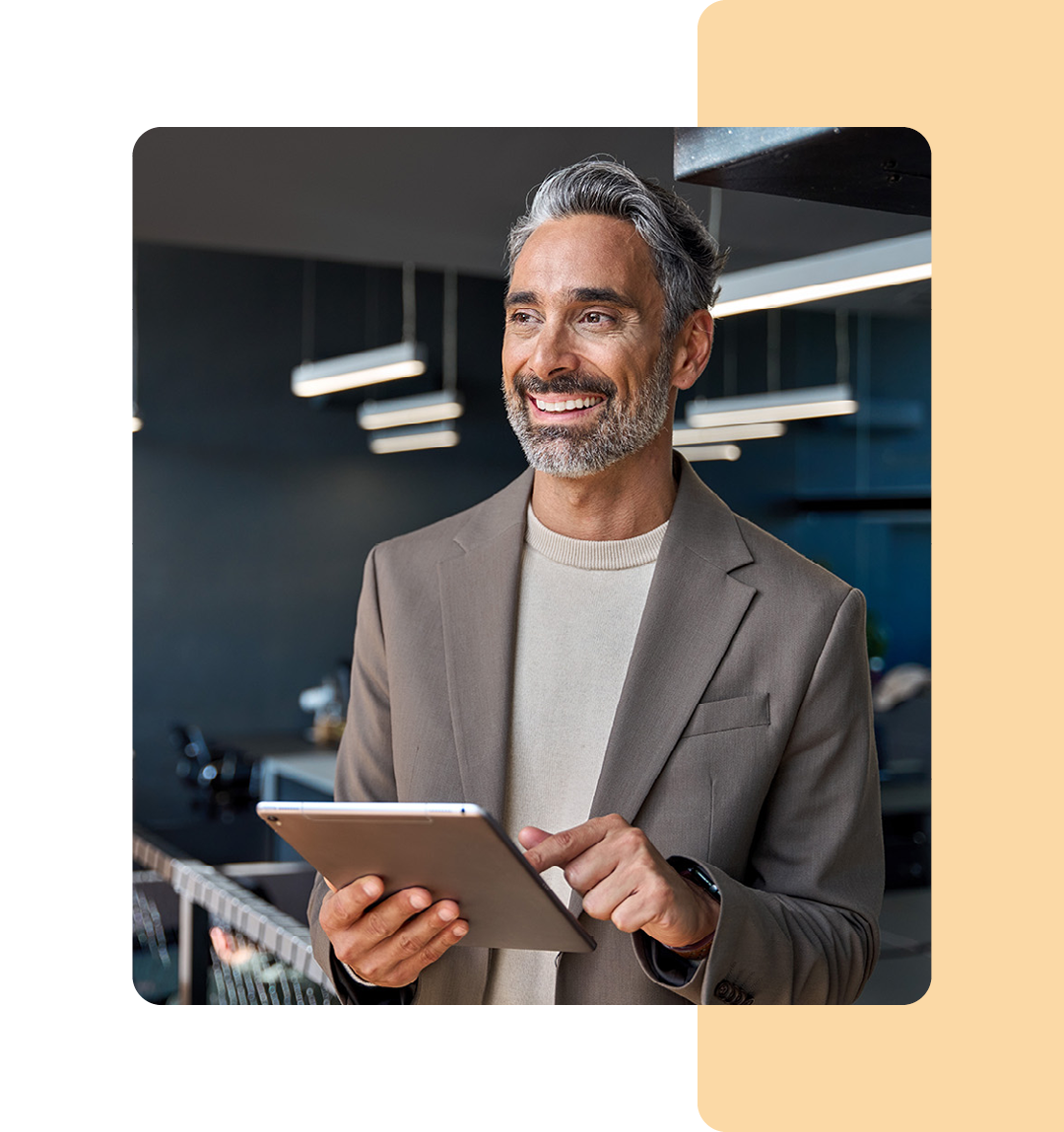 Image of a business professional stood holding a tablet