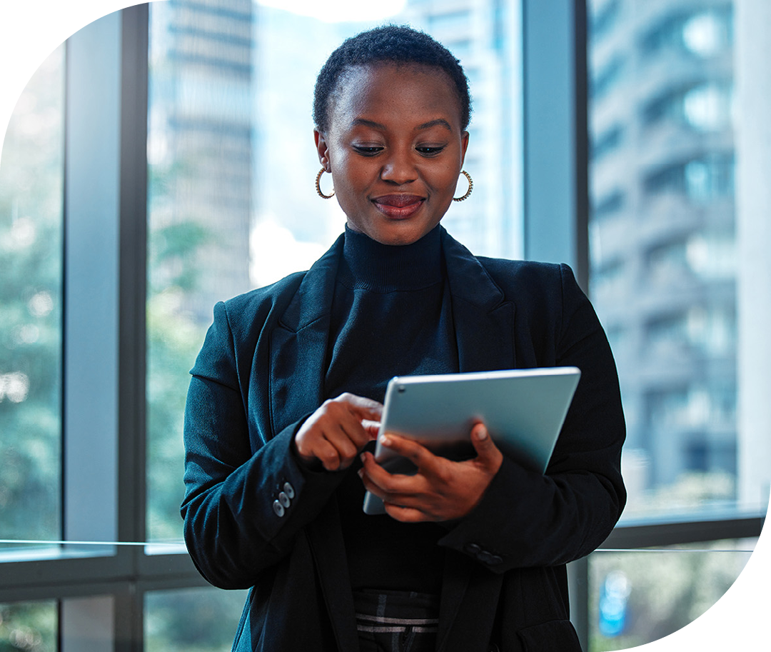 Image of a business professional stood in an office holding a tablet