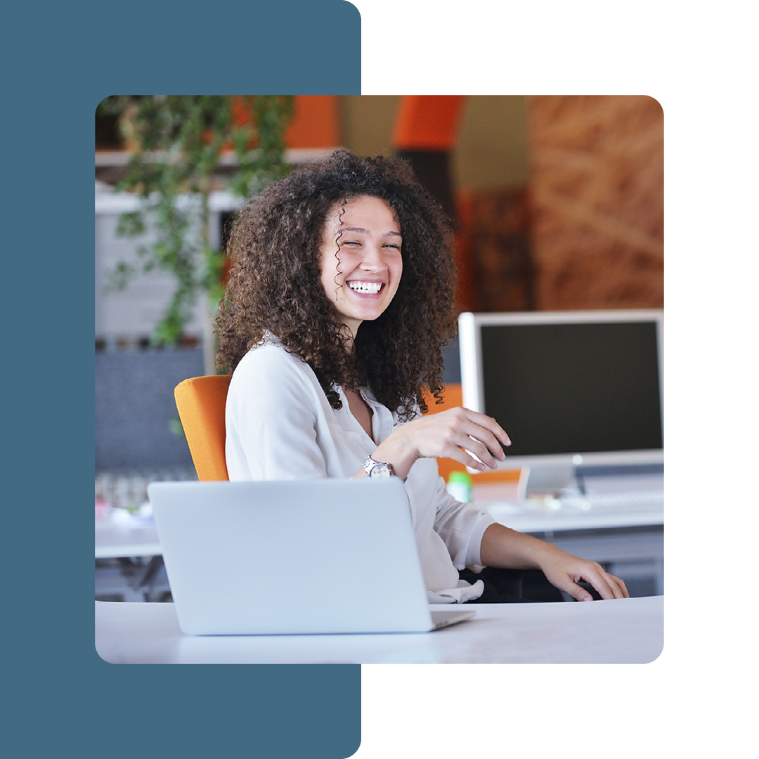 Image of a smiling person sat in an office