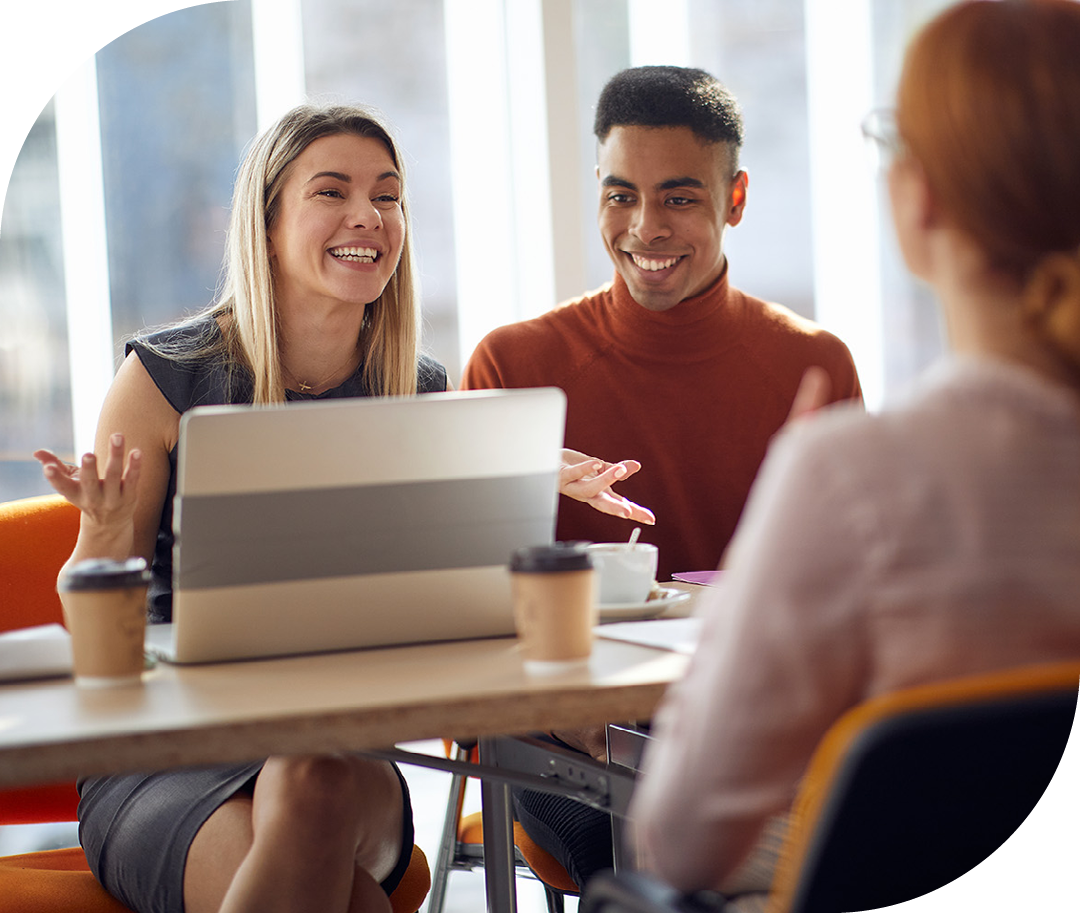 Image of a group of colleagues conversing in a meeting