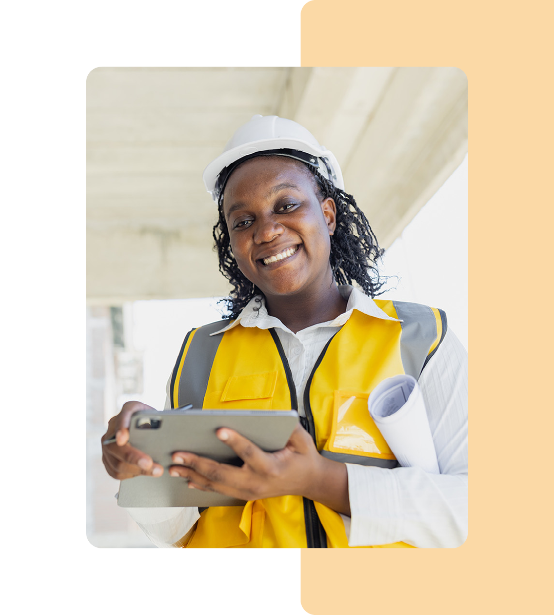 Image of a smiling construction worker holding a tablet