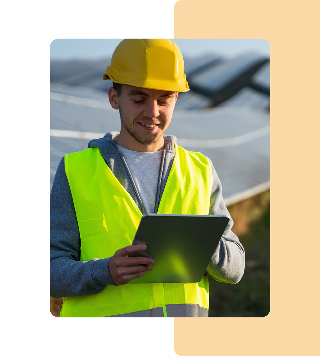 Image of a solar panels specialists working on a tablet in a field of solar panels