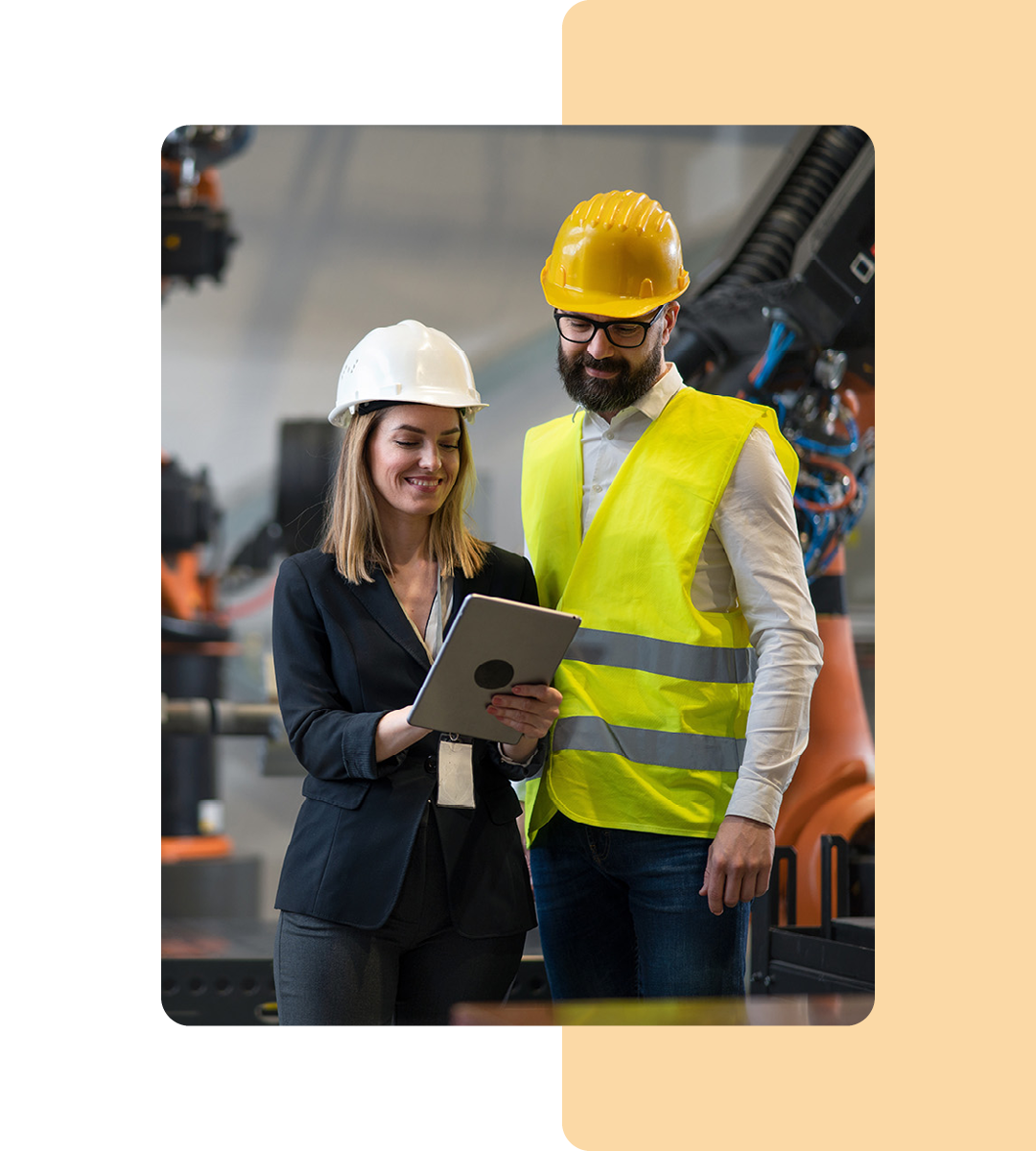 Image of two workers holding a tablet in a manufacturing factory