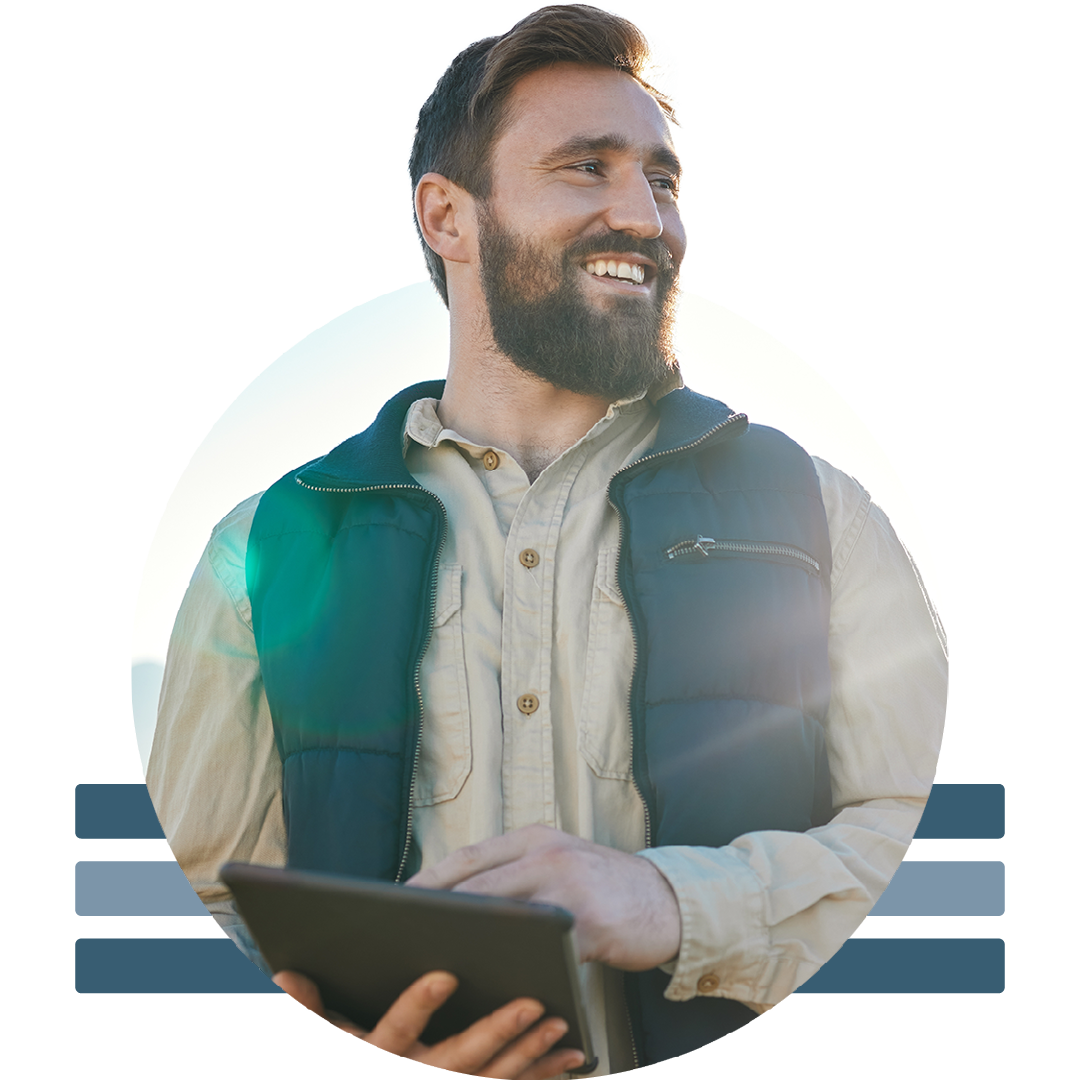 Image of a smiling farmer holding a tablet