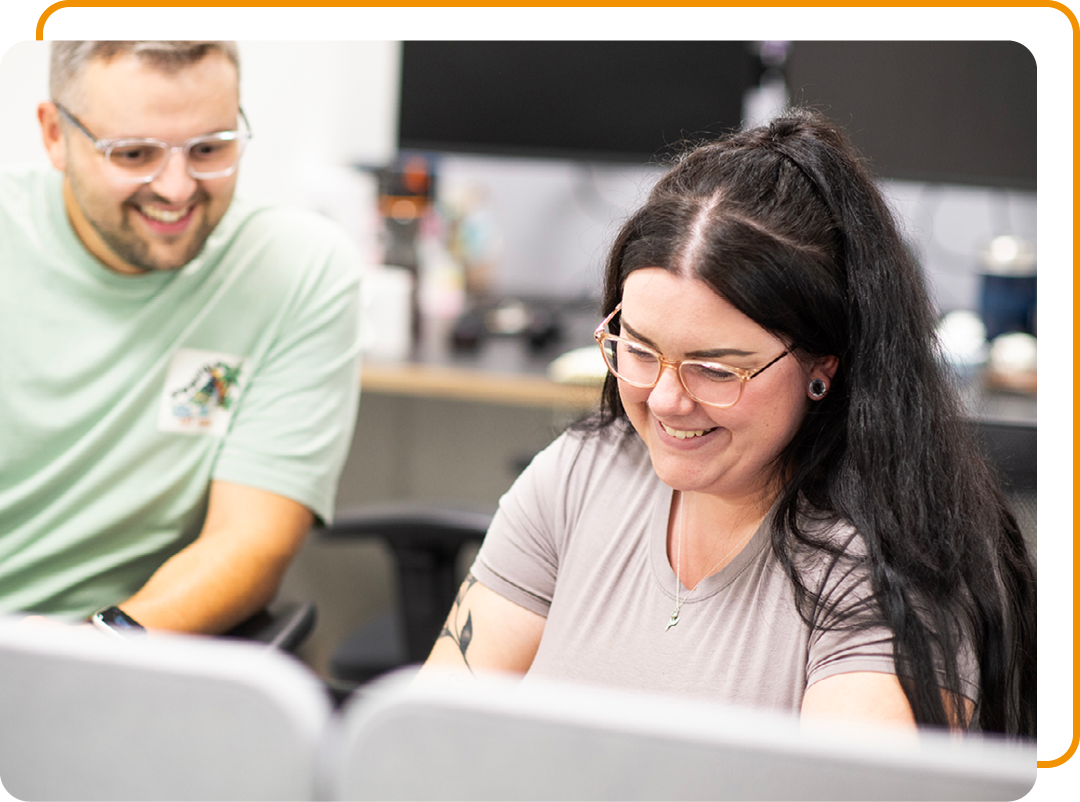 Image of two Phoenix Software employees conversing at a desk