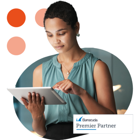 Image of a business professional working on a tablet with our Barracuda Premier Partner logo