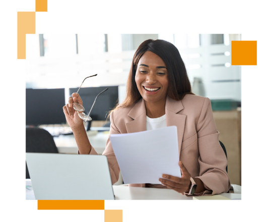 Image of a business professional sat at a desk looking at information on paper