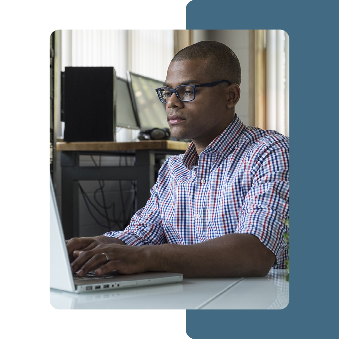 Image of an IT professional working on a laptop