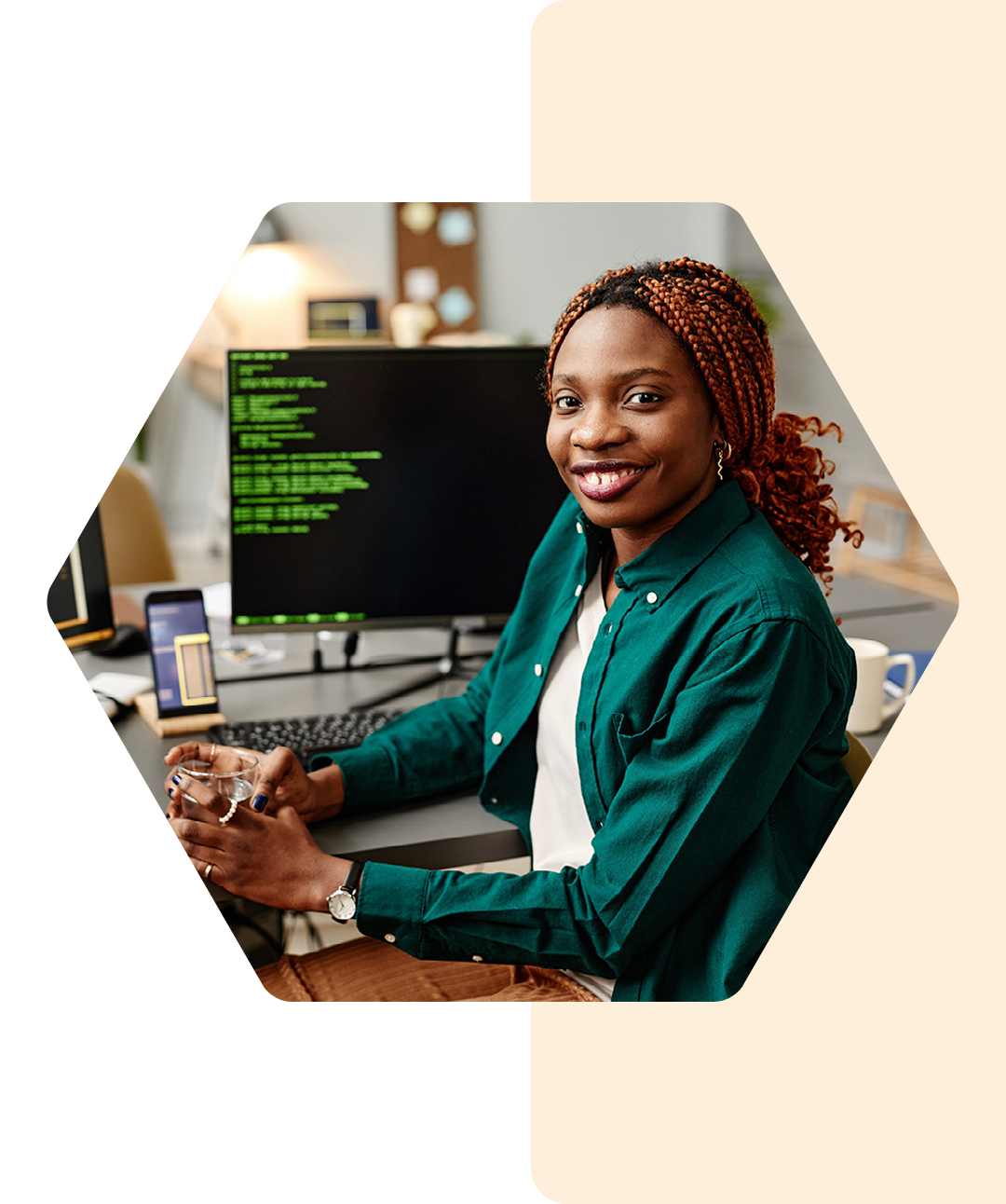 Image of a smiling IT developer working on a computer