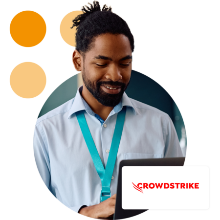 Image of an IT professional stood in a office holding a tablet with the Crowdstrike logo