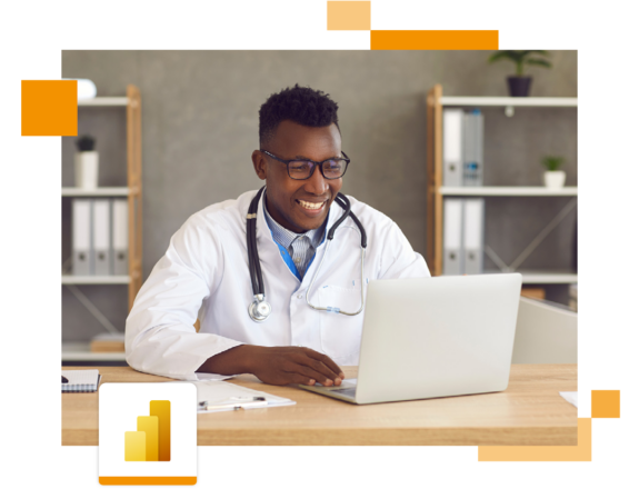 Image of a smiling doctor working on a laptop in an office