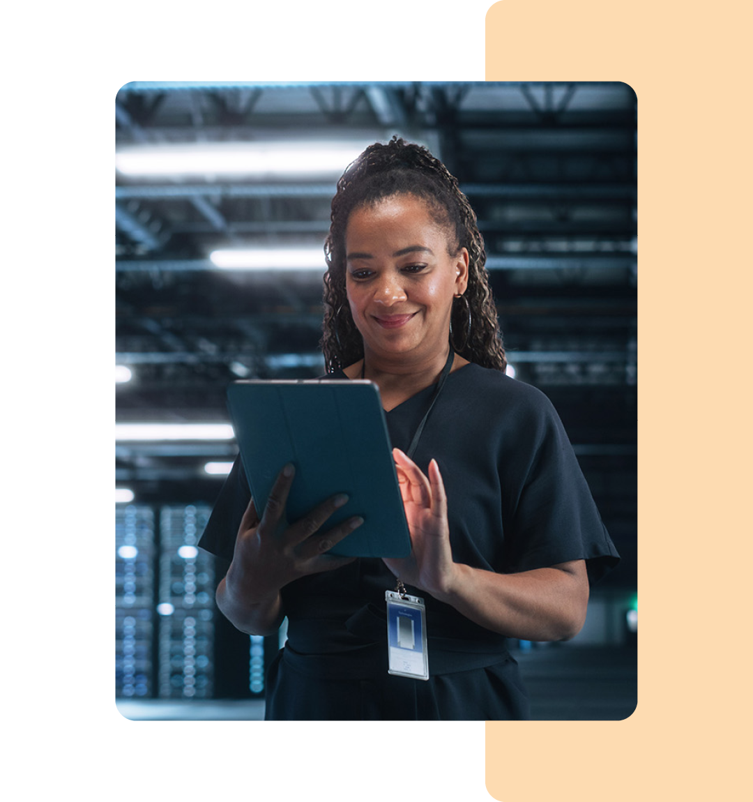 Image of an IT professional working on a tablet in a data storage room