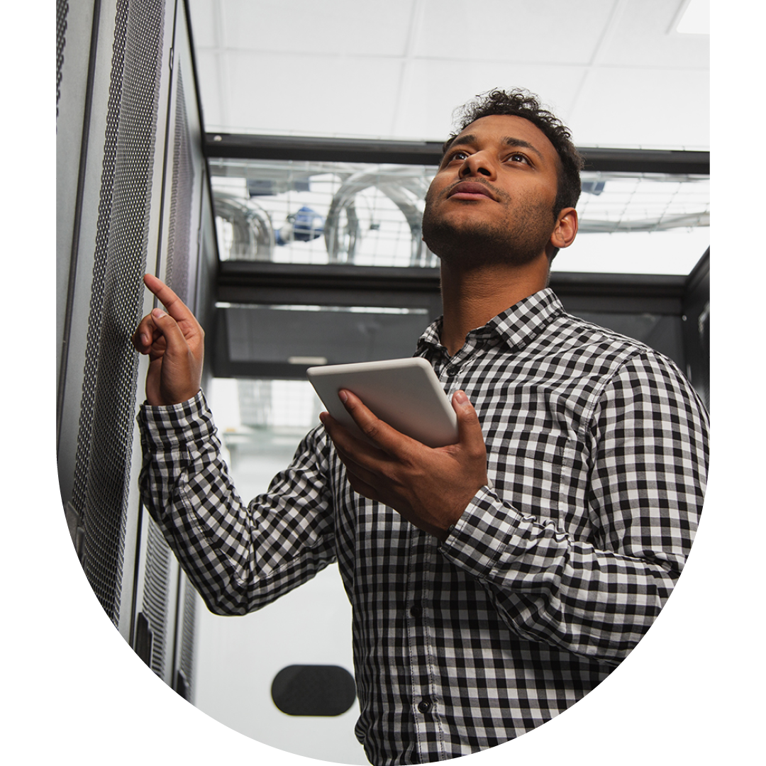 Image of an IT professional walking through a server room