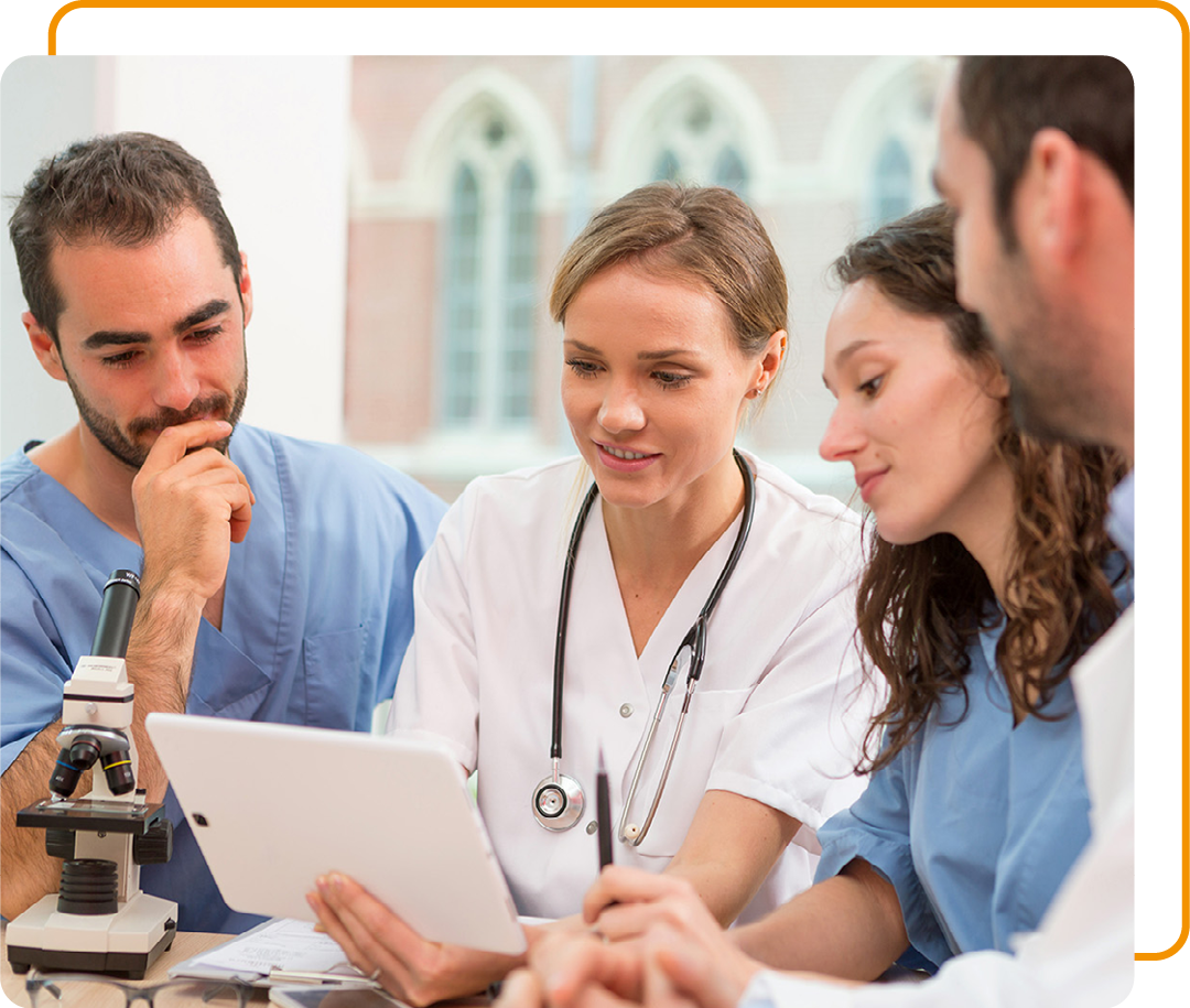 Image of a group of doctors looking at information on a tablet