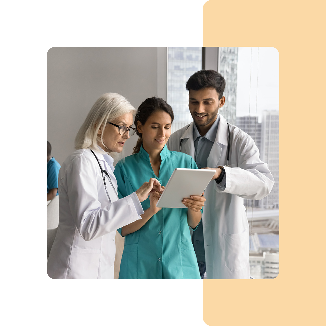 Image of a group of doctors stood looking at a tablet