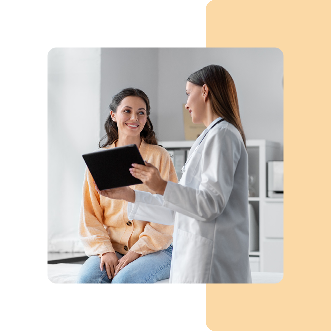 Image of a doctor stood showing a patient information on a tablet