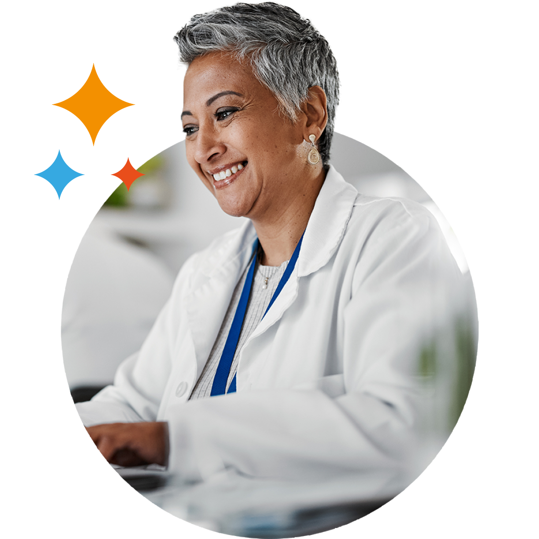 Image of a smiling doctor working on a laptop