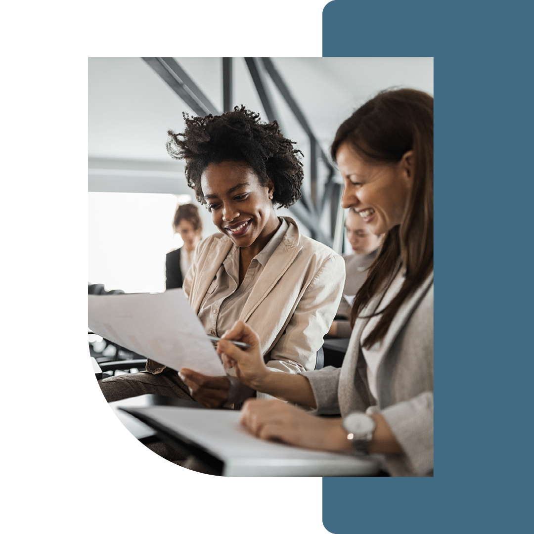 Image of two people working through documents together