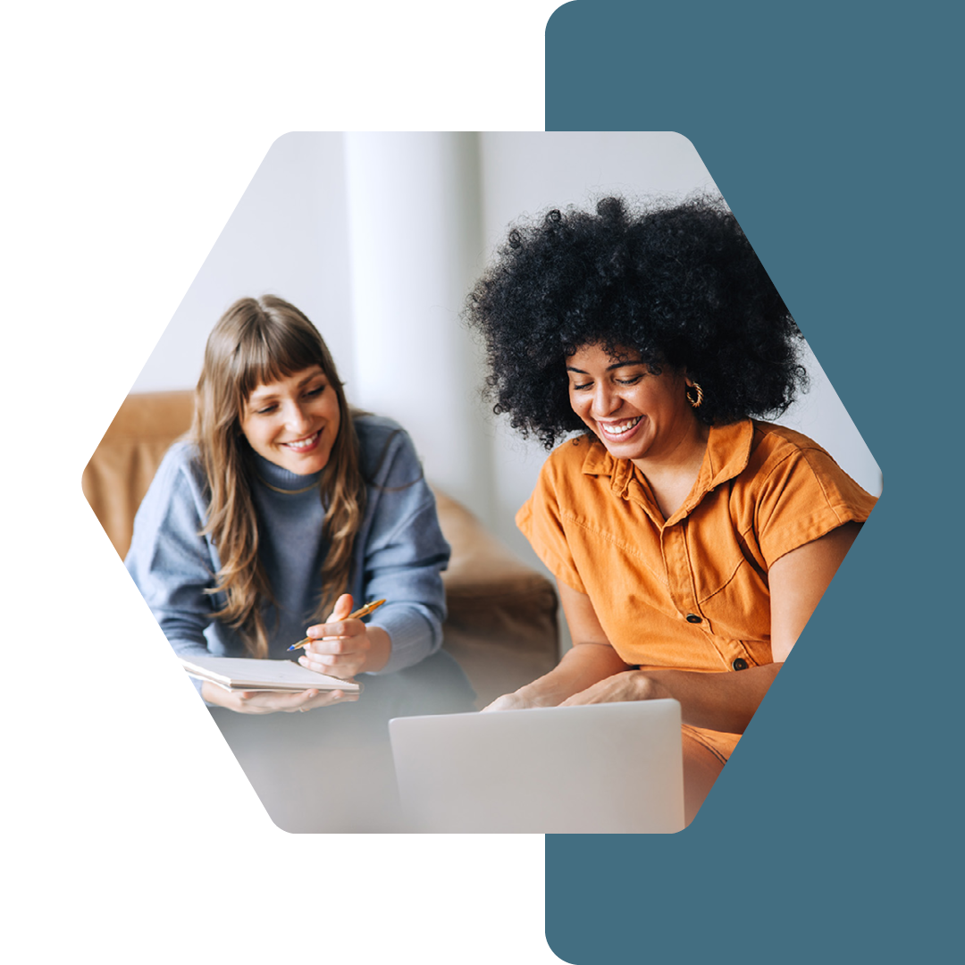 Image of two people working together on a laptop