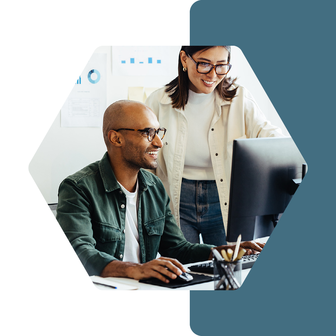 Image of two people working together on a computer