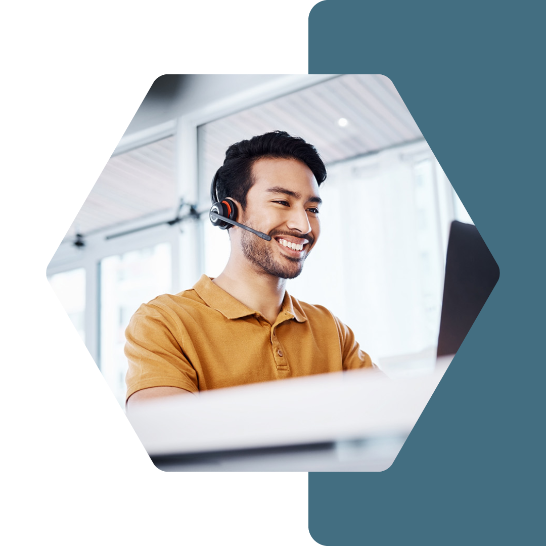 Image of a person at a desk talking on a headset