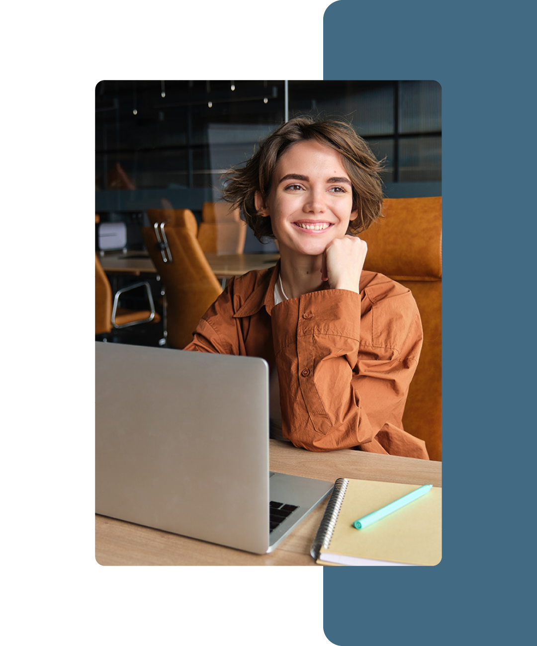 Image of a smiling working professional working on a laptop