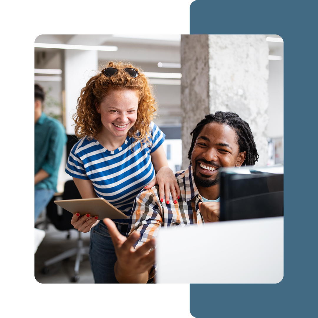 Image of two colleagues sat collaborating at a desk