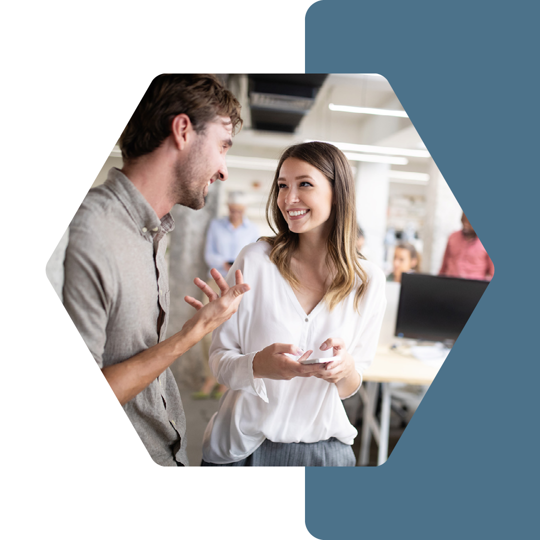 Image of two people laughing in conversation