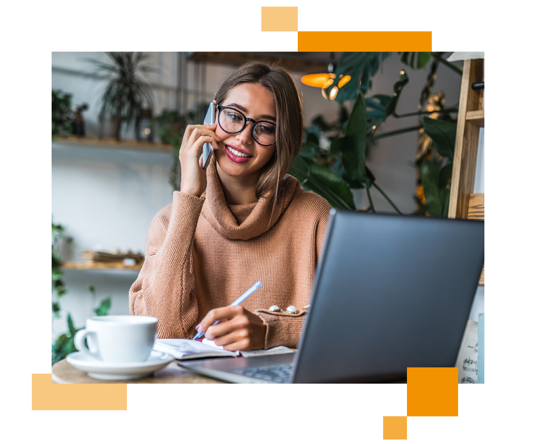 Image of a remote worker talking on a mobile phone and working on a laptop