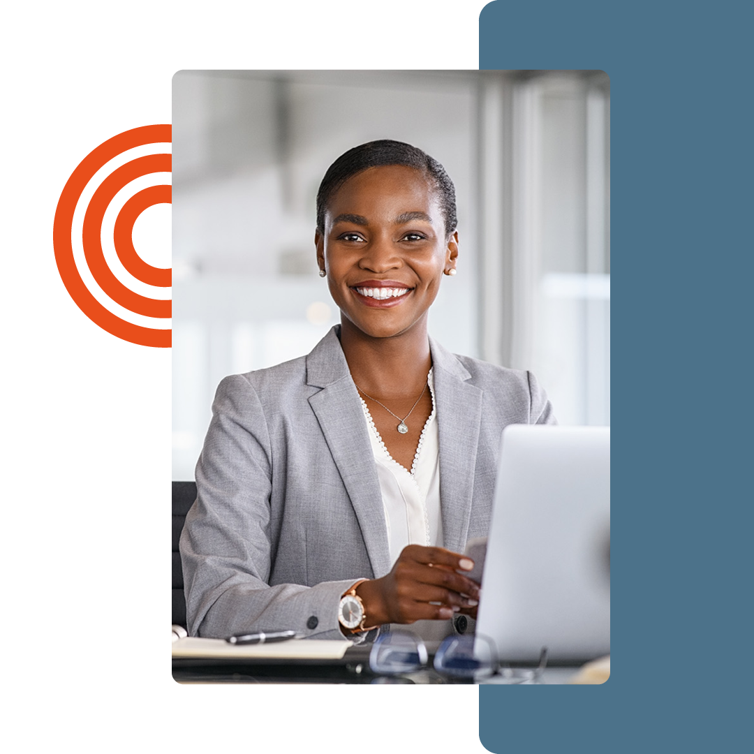 Image of a smiling person working at a desk