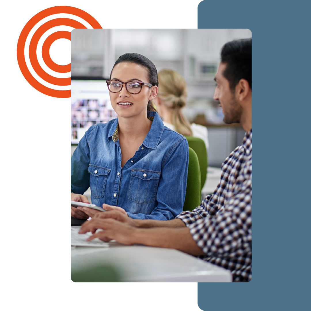 Image of two people working together at a desk