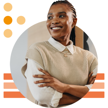 Image of a smiling working professional stood with arms folded