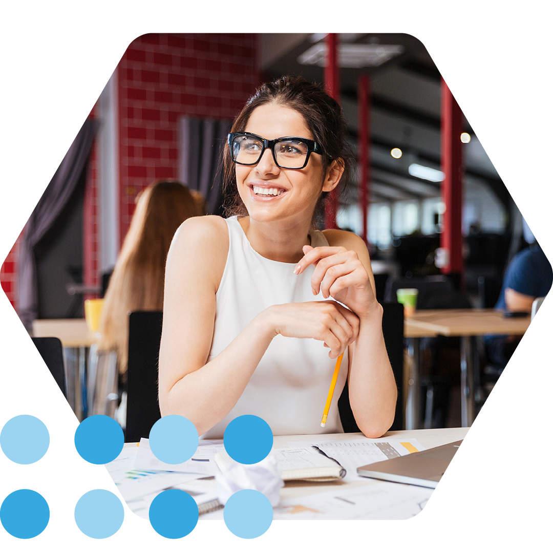 Image of a smiling working professional sat at a desk