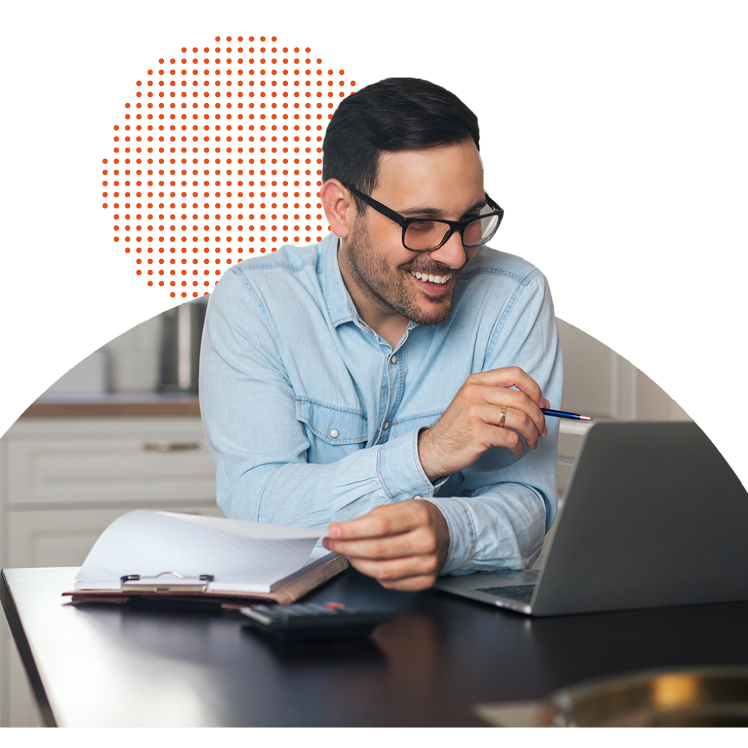 Person smiling while working on a laptop remotely