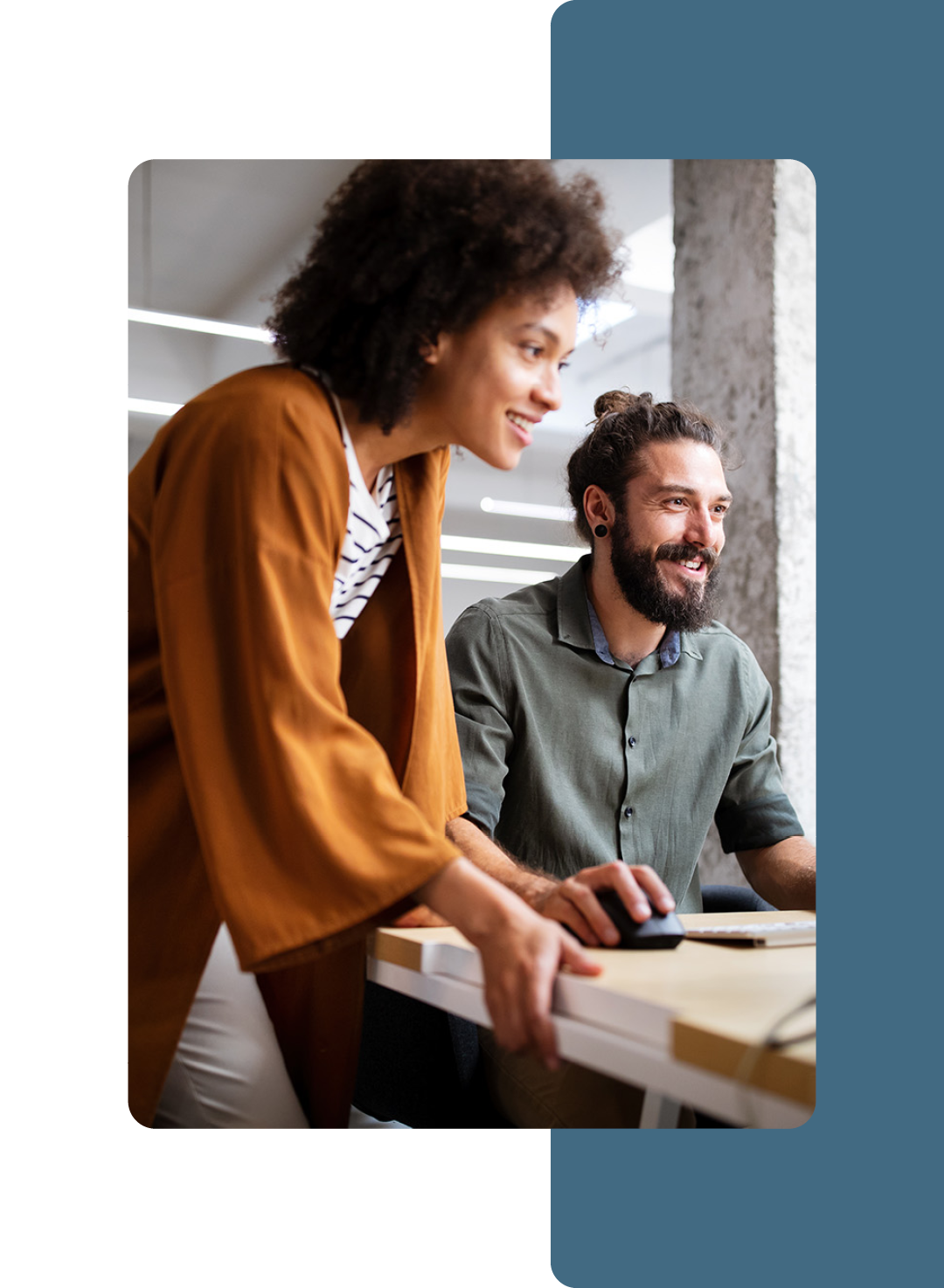 Image of two colleagues collaborating at a computer