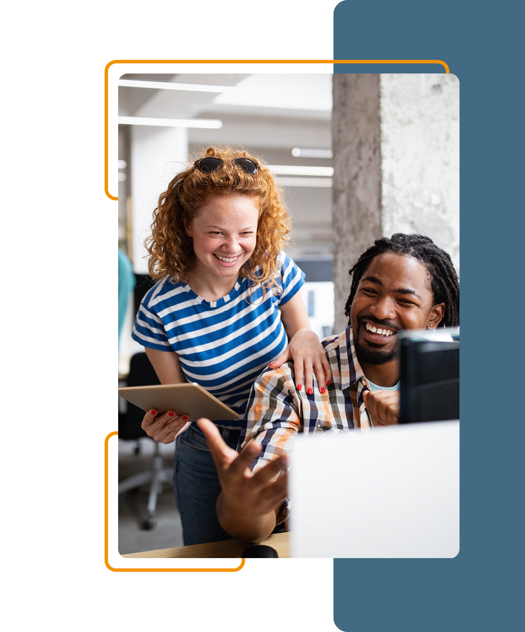 Image of two people working together on a computer