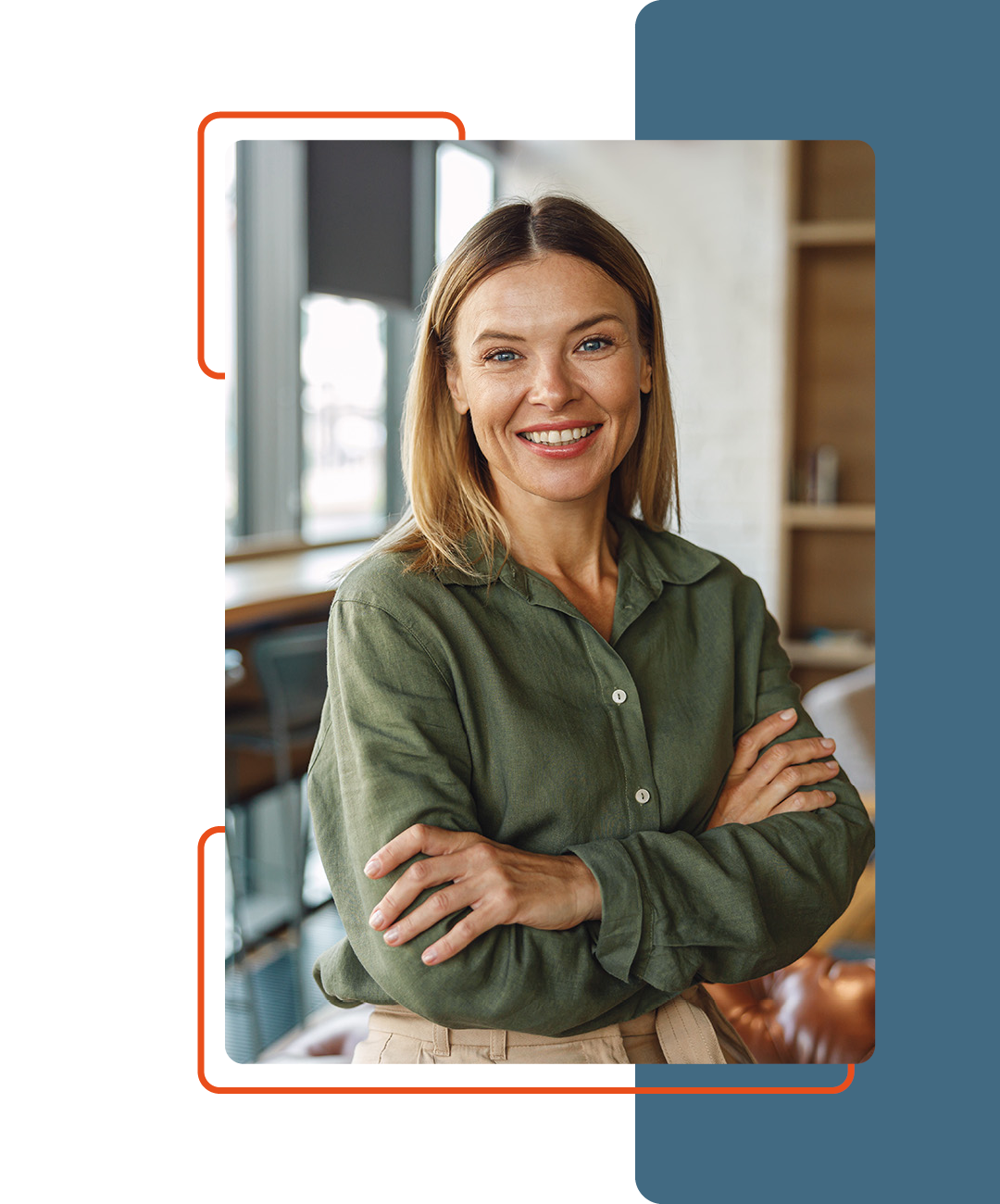 Image of a person smiling with their arms crossed stood up in an office