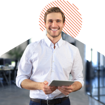 Image of a smiling person holding a tablet on an office background