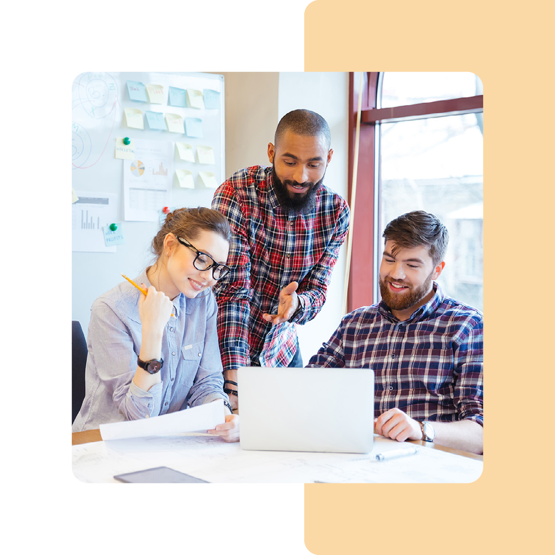 Image of a group of coworkers collaborating around a laptop