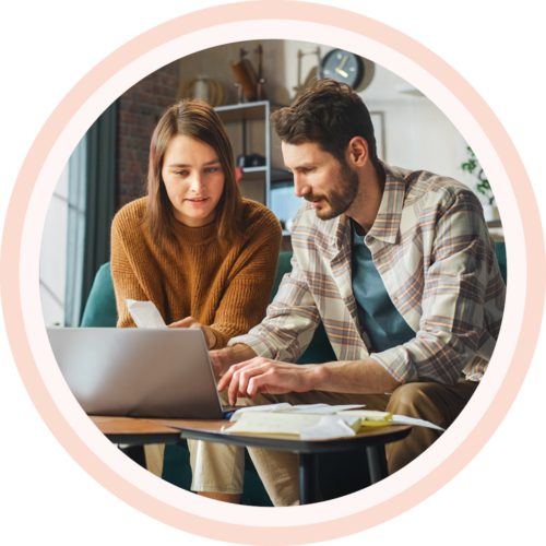 Image of two colleagues coworking on a laptop