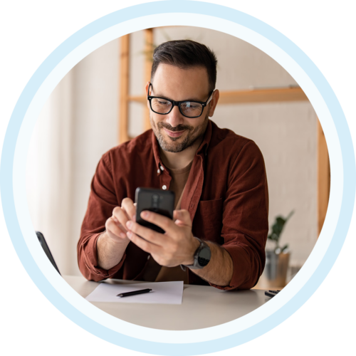 Image of a smiling work professional working on a mobile phone