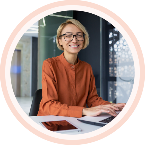 Image of a smiling work professional working on a laptop