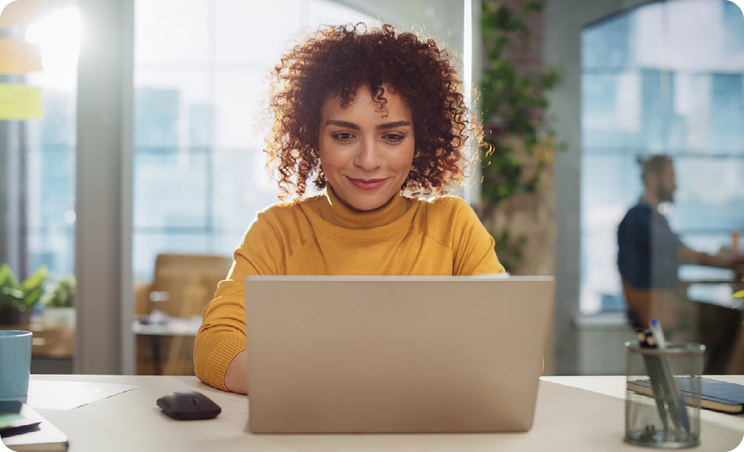 Image of a working professional sat at a laptop