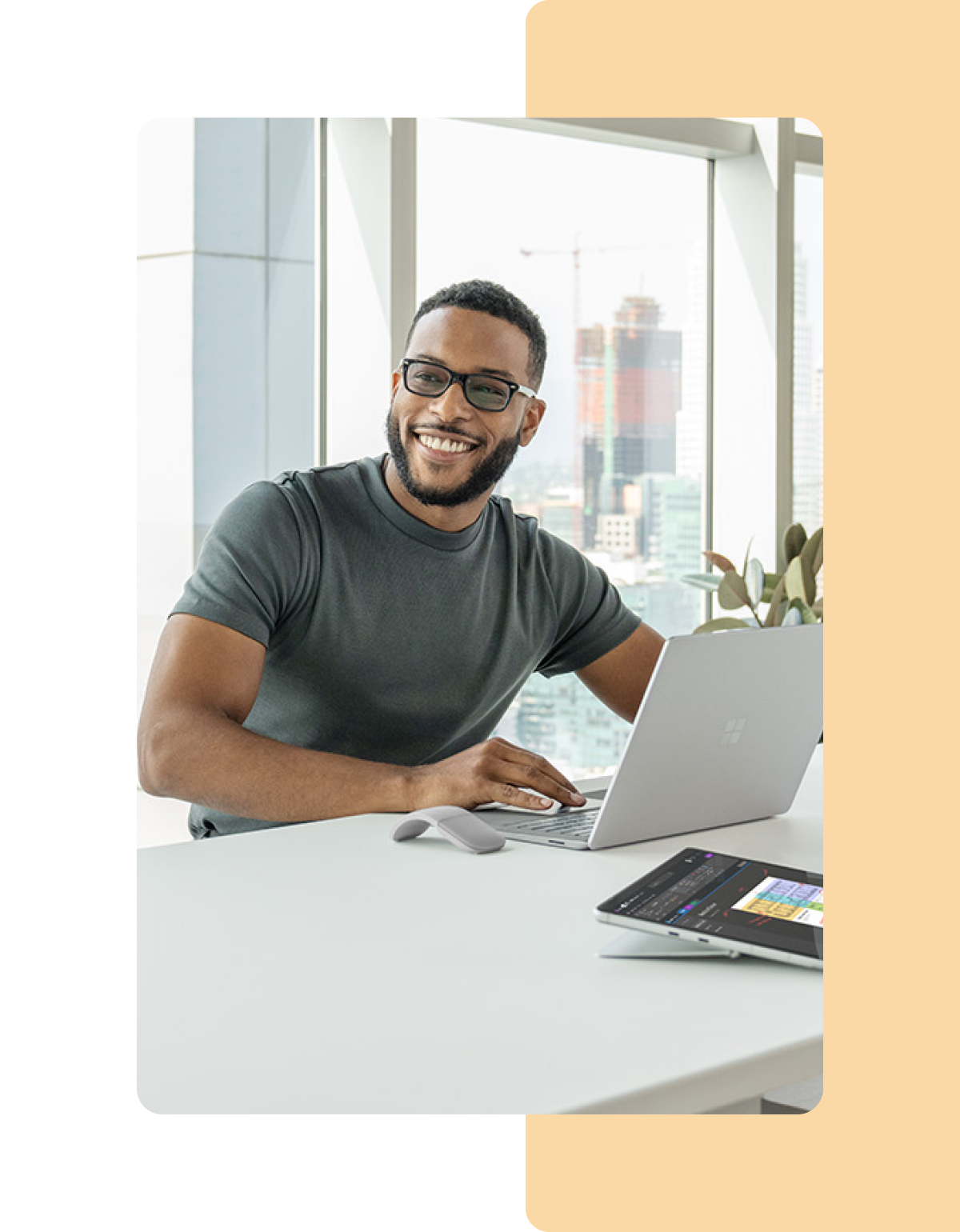 Image of a person working in an office on a Microsoft Surface laptop