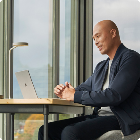 Image of a person working on a Microsoft Surface laptop