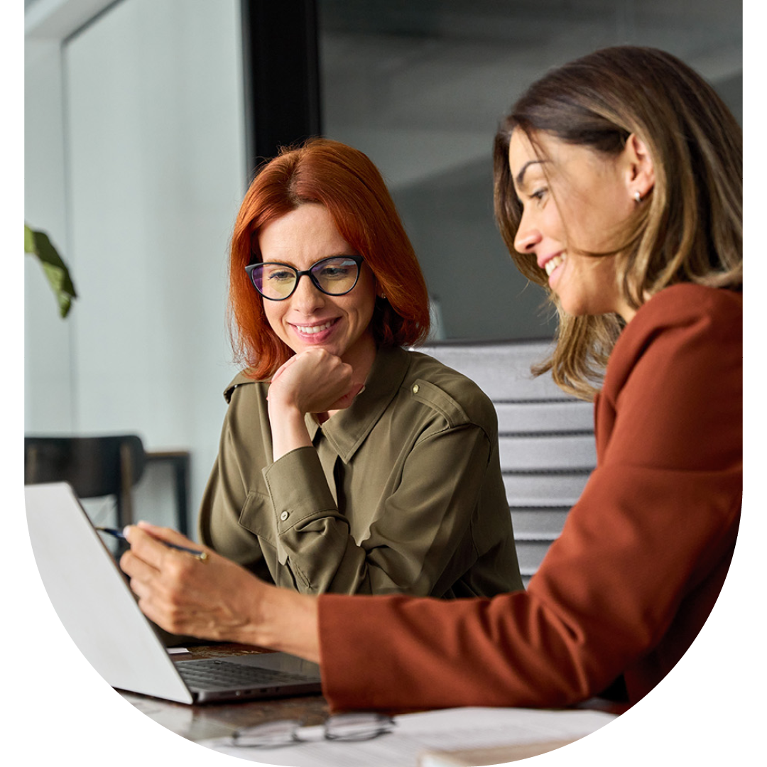 Image of two colleagues collaborating on a laptop