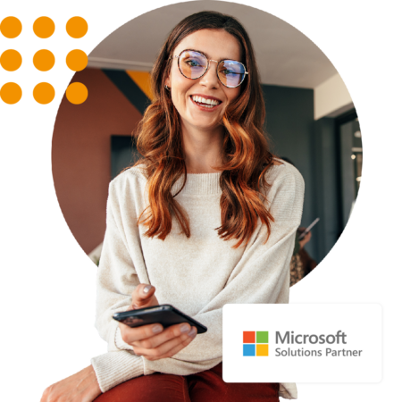 Image of a smiling person in an office environment with our Microsoft Solutions Partner logo