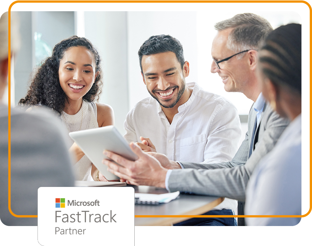 Image of a group of people sat around a desk with Phoenix's Microsoft FastTrack partner logo