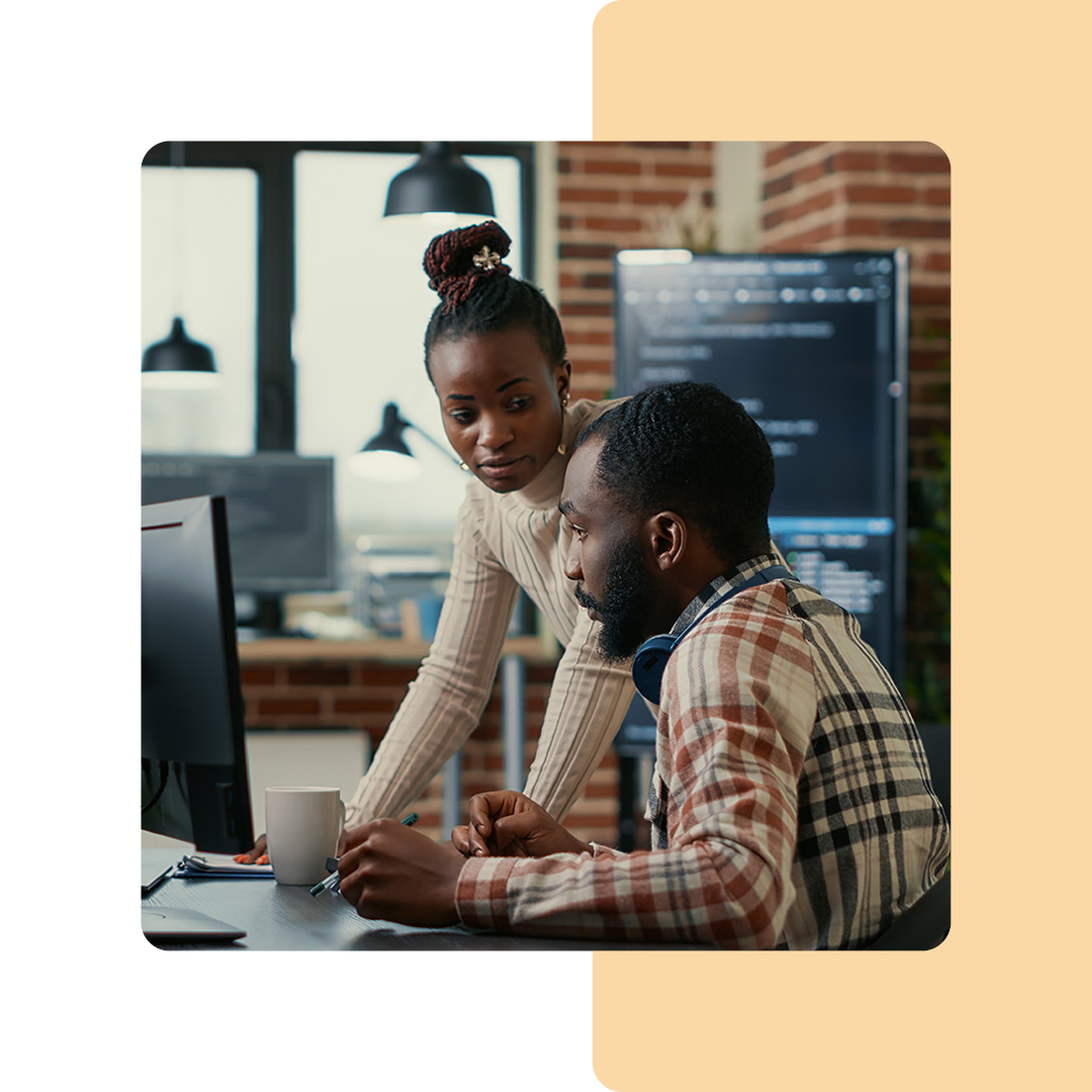 Image of two cyber security professionals working on a computer